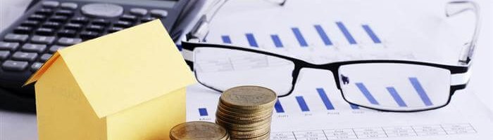 כסף, מחשבון, דגם של בית ומשקפיים.